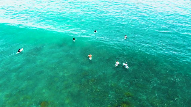 PUNTA BUZZARDS EAST CAPE BCS MEXICO-2022: Surfers Waiting for Waves in Clear Turquoise Water