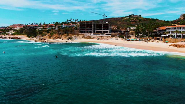 PUNTA BUZZARDS EAST CAPE BCS MEXICO-2022: Waves Rolling Onto Sandy Beach with Swimmers