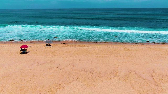 PUNTA BUZZARDS EAST CAPE BCS MEXICO-2022: Beachgoers Under Umbrellas with Ocean Waves