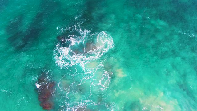 PUNTA BUZZARDS EAST CAPE BCS MEXICO-2022: Waves Crashing on Submerged Rocks in Clear Turquoise Water