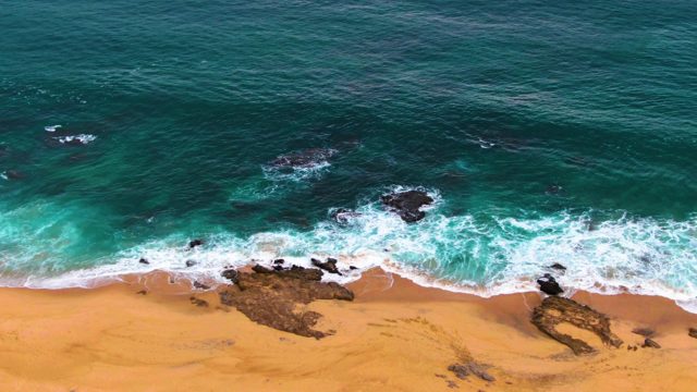 PUNTA BUZZARDS EAST CAPE BCS MEXICO-2022: Ocean Waves Breaking on Sandy Beach with Rocks