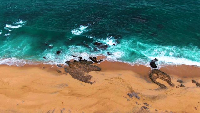 PUNTA BUZZARDS EAST CAPE BCS MEXICO-2022: Waves Crashing on Sandy Beach with Rocks