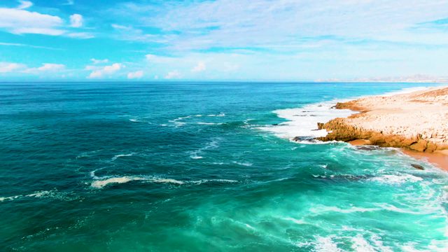 PUNTA BUZZARDS EAST CAPE BCS MEXICO-2022: Ocean Waves Crashing on Rocky Coastline Aerial View