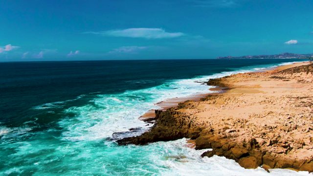 PUNTA BUZZARDS EAST CAPE BCS MEXICO-2022: Ocean Waves Crashing on Rocky Sandy Shore