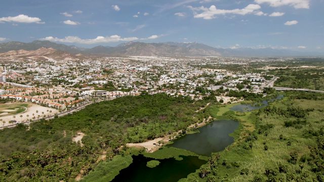 SAN JOSE DEL CABO BCS MEXICO-2022: Cityscape with Green Park and Ponds
