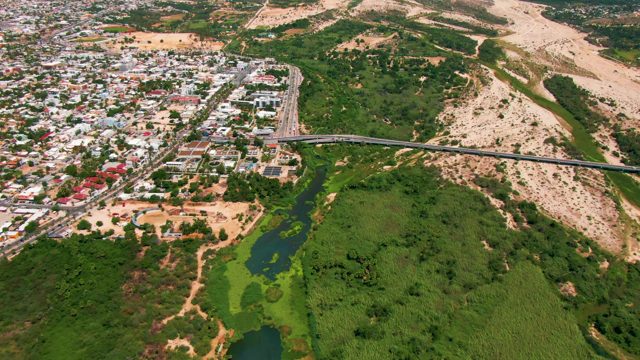 SAN JOSE DEL CABO BCS MEXICO-2022: Vehicles Traveling on Overpass Between Urban and Green Areas