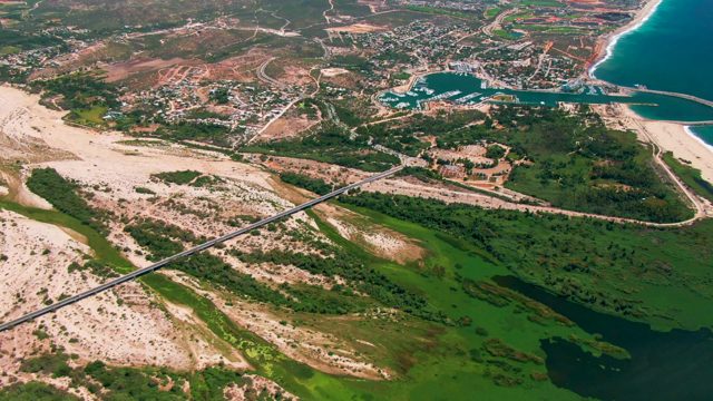 SAN JOSE DEL CABO BCS MEXICO-2022: Coastal Bridge Spanning Sandy Shore and Marina