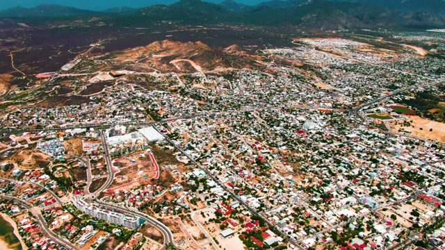 SAN JOSE DEL CABO BCS MEXICO-2022: Urban Landscape with Curved Roads and Distant Hills