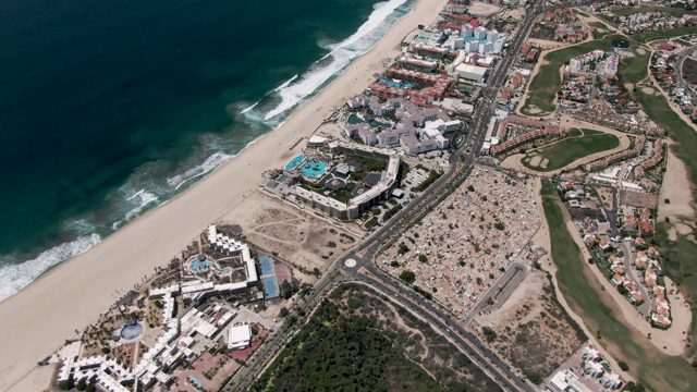SAN JOSE DEL CABO BCS MEXICO-2022: Coastal Highway Traffic and Sandy Beach