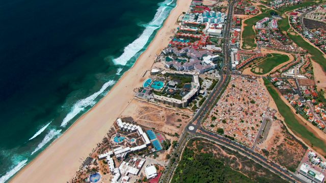 SAN JOSE DEL CABO BCS MEXICO-2022: Ocean Waves Moving Toward Shore Along Coastal Road