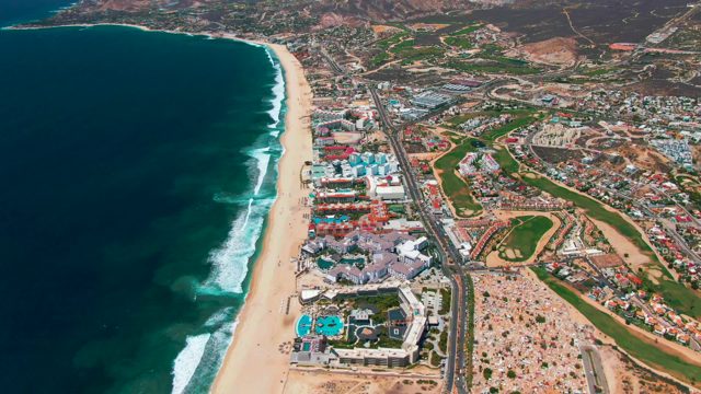 SAN JOSE DEL CABO BCS MEXICO-2022: Vehicles Moving Along Coastal Road Beside Beach and Ocean