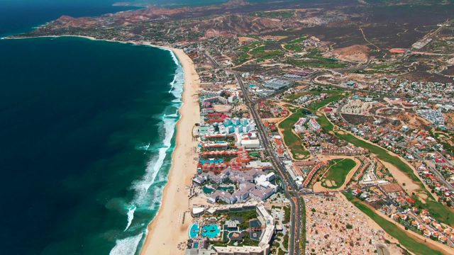 SAN JOSE DEL CABO BCS MEXICO-2022: Coastal Shoreline with Beach and Roadside Buildings