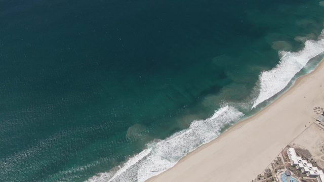 SAN JOSE DEL CABO BCS MEXICO-2022: Waves Rolling Onto Sandy Beach Coastline