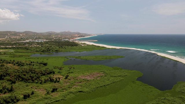SAN JOSE DEL CABO BCS MEXICO-2022: Lagoon, Sandy Beach, and Ocean with Shifting Clouds