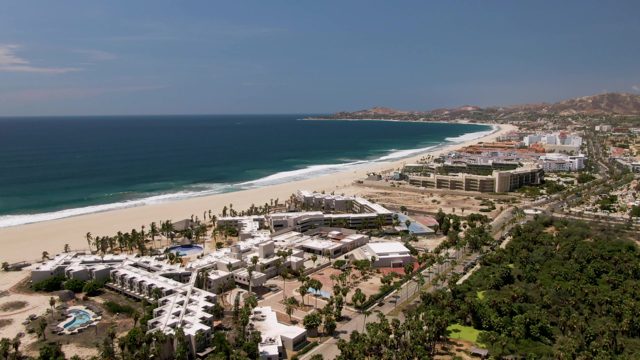 SAN JOSE DEL CABO BCS MEXICO-2022: Coastal Road Traffic with Beach and Buildings