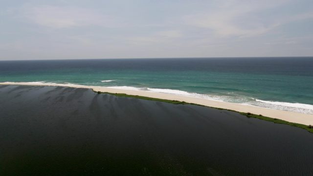 SAN JOSE DEL CABO BCS MEXICO-2022: Waves Rolling Onto Sandy Shore From Cliff Edge