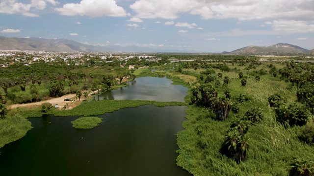 SAN JOSE DEL CABO BCS MEXICO-2022: Car Moving Along a Riverbank Dirt Path