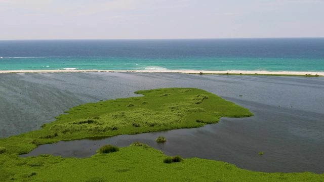 Green Island Lagoon with Boat Passing By