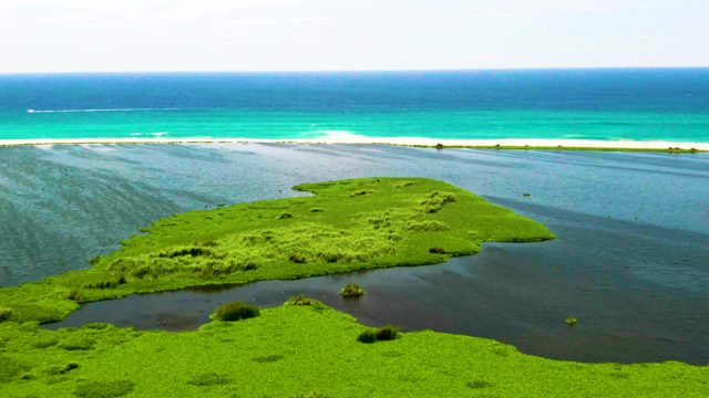 Coastal Lagoon and Ocean with Moving Boat