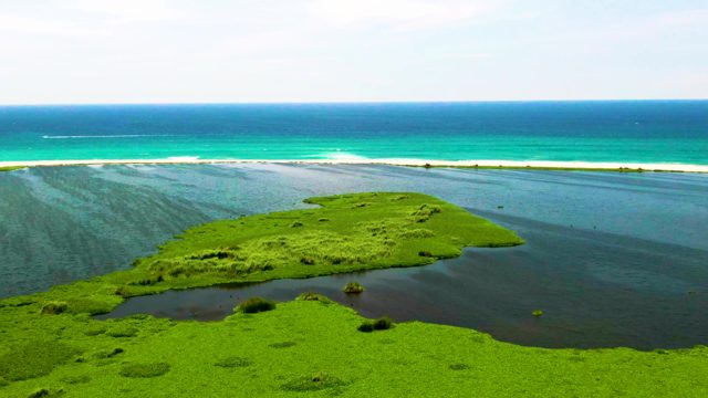 Coastal Lagoon and Ocean with Boat in Motion