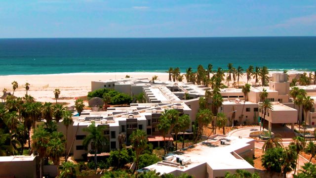 Beachfront Buildings and Moving Car on Road