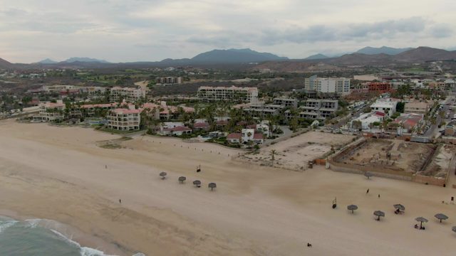 Sandy Beach with Decreasing Visitors and Shifting Umbrellas