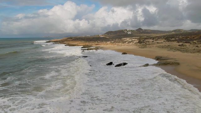 PUNTA GORDO EAST CAPE BCS MEXICO-2022: Waves Crashing on Sandy Beach with Rocky Outcrops