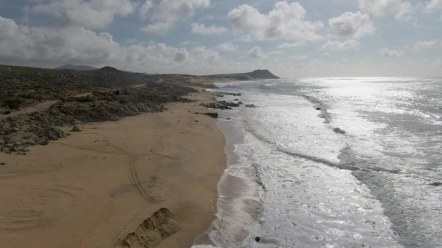 PUNTA GORDO EAST CAPE BCS MEXICO-2022: Waves Rolling Onto Sandy Shore with Rocky Outcrops
