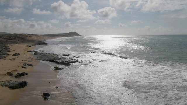 PUNTA GORDO EAST CAPE BCS MEXICO-2022: Waves Crashing on Rocky Shoreline with Sandy Beach