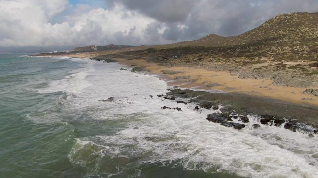 PUNTA GORDO EAST CAPE BCS MEXICO-2022: Ocean Waves Breaking on Sandy Beach with Rocky Shores
