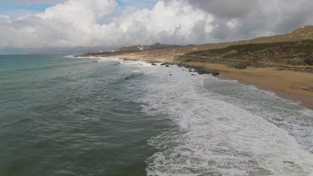 PUNTA GORDO EAST CAPE BCS MEXICO-2022: Waves Crashing Onto Sandy Shoreline with Rocky Outcrops