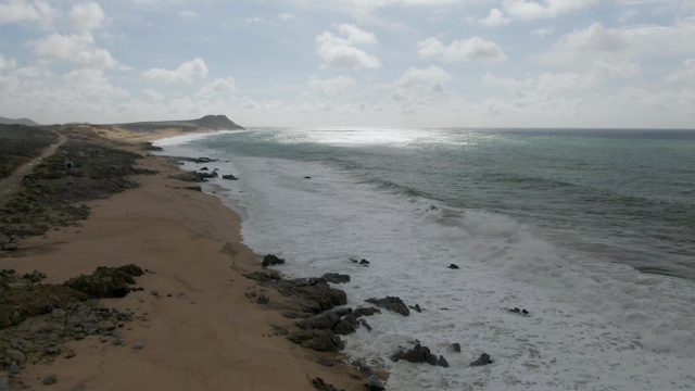 PUNTA GORDO EAST CAPE BCS MEXICO-2022: Waves Rolling Onto Sandy Beach with Rocky Shores