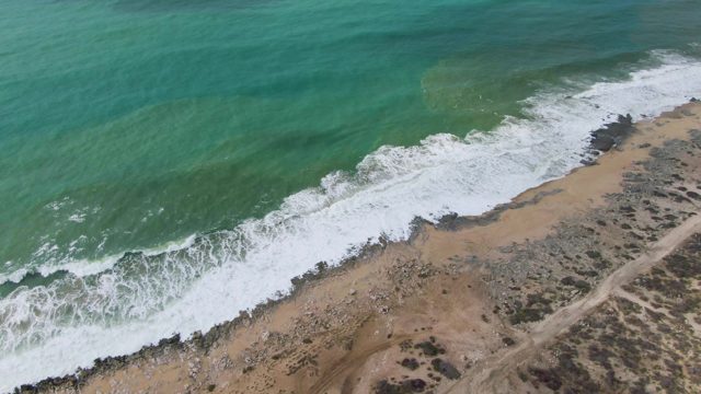 PUNTA GORDO EAST CAPE BCS MEXICO-2022: Waves Rolling Onto Sandy Beach with Rocky Patches