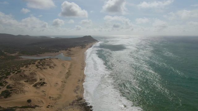 PUNTA GORDO EAST CAPE BCS MEXICO-2022: Waves Rolling Along Sandy Beach Coastline