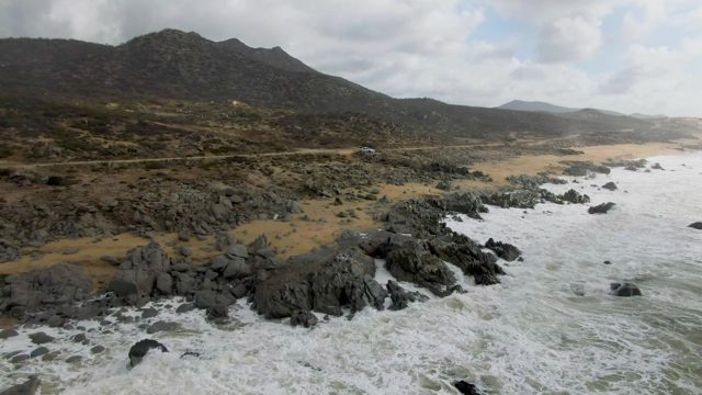 PUNTA GORDO EAST CAPE BCS MEXICO-2022: Waves Crashing on Rocky Shore with Coastal Road
