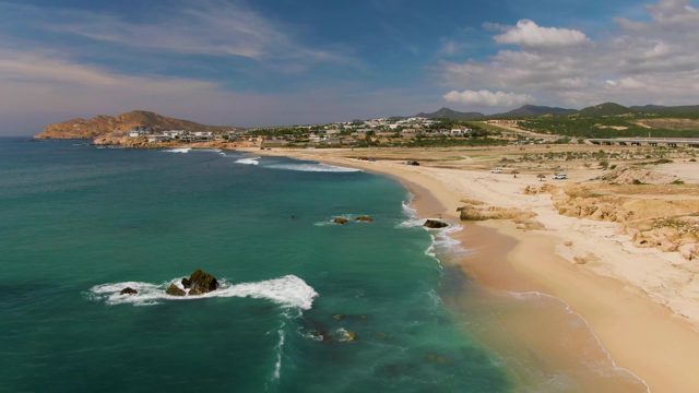 EL TULE LOS CABOS BCS MEXICO-2022: Waves Hitting Rocks Along Sandy Coastline