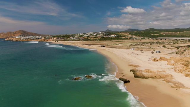 EL TULE LOS CABOS BCS MEXICO-2022: Gentle Ocean Waves on Sandy Beach with Vehicles