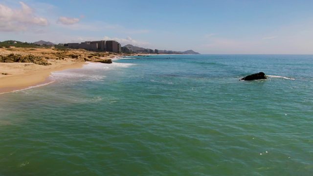 EL TULE LOS CABOS BCS MEXICO-2022: Waves Lapping a Sandy Shore with Rocky Outcrop