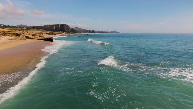 EL TULE LOS CABOS BCS MEXICO-2022: Waves Crashing Onto Sandy Shoreline