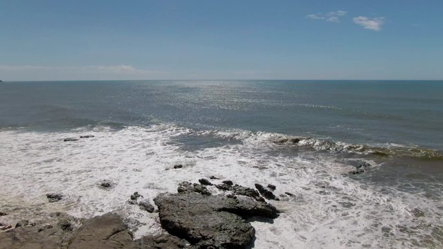 BUZZARDS EAST CAPE LOS CABOS BCS MEXICO-2022: Waves Crashing on Rocky Shore with Distant Headland