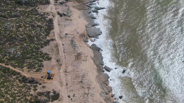 BUZZARDS EAST CAPE LOS CABOS BCS MEXICO-2022: Coastal Beach with Rocky Shore and Moving Ocean Waves