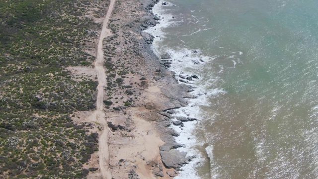 BUZZARDS EAST CAPE LOS CABOS BCS MEXICO-2022: Coastal Dirt Road with Moving Ocean Waves