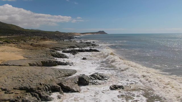 BUZZARDS EAST CAPE LOS CABOS BCS MEXICO-2022: Waves Crashing Against Rocky Coastline