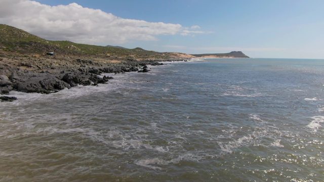 BUZZARDS EAST CAPE LOS CABOS BCS MEXICO-2022: Waves Crashing on Rocky Coastal Shoreline