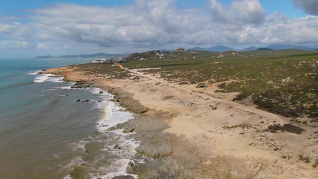 BUZZARDS EAST CAPE LOS CABOS BCS MEXICO-2022: Coastal Beach with Moving Vehicle and Ocean Waves