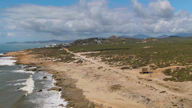 BUZZARDS EAST CAPE LOS CABOS BCS MEXICO-2022: Sandy Coastline with Ocean Waves and Distant Hills