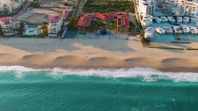 SAN JOSE DEL CABO BCS MEXICO-2022: Coastal Beach with Moving Ocean Waves and Buildings