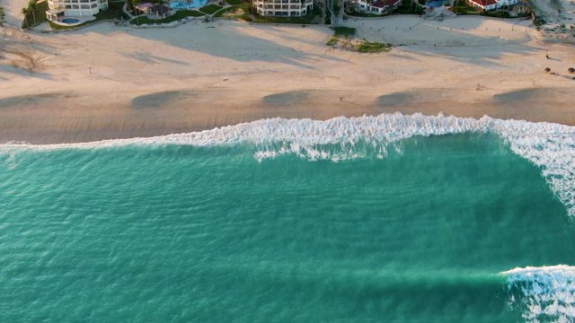 SAN JOSE DEL CABO BCS MEXICO-2022: Gentle Ocean Waves Rolling Toward Sandy Shore