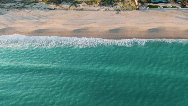 SAN JOSE DEL CABO BCS MEXICO-2022: Waves Rolling Onto Sandy Shore From Above