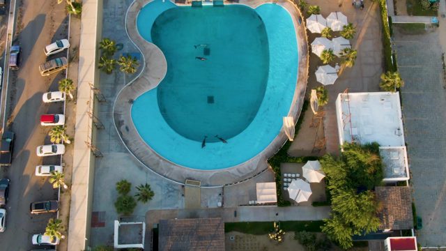SAN JOSE DEL CABO BCS MEXICO-2022: People Swimming in a Curved Pool